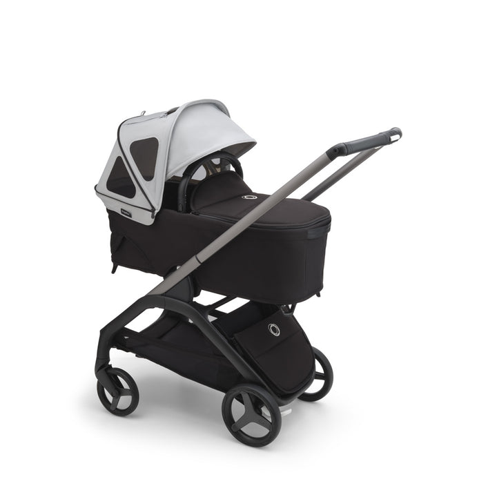 Bugaboo Dragonfly Breezy Sun Canopy open on a bassinet in -- Color_Misty Grey