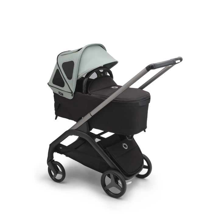 Bugaboo Dragonfly Breezy Sun Canopy open on a bassinet in -- Color_Pine Green