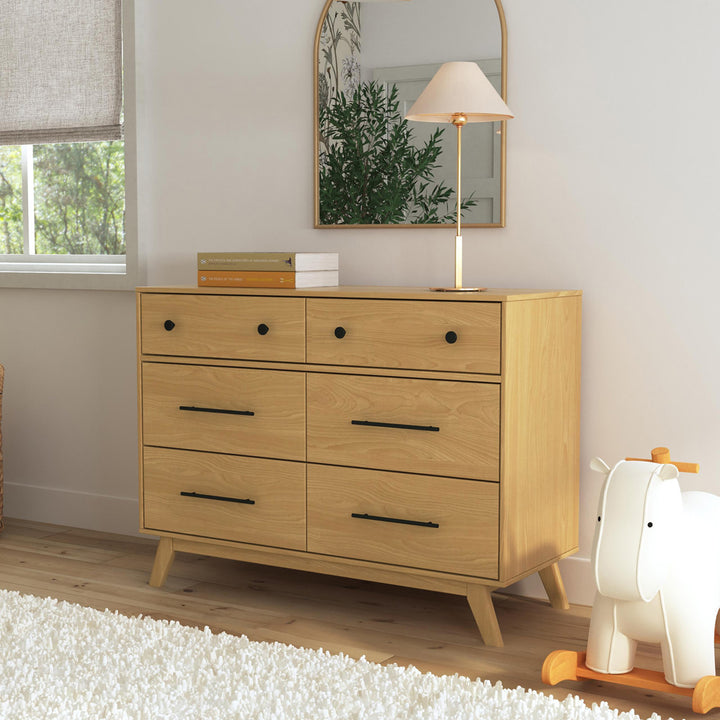 DaVinci Otto 6-Drawer Dresser under a mirror next to a horse rocker  in -- Color_Honey