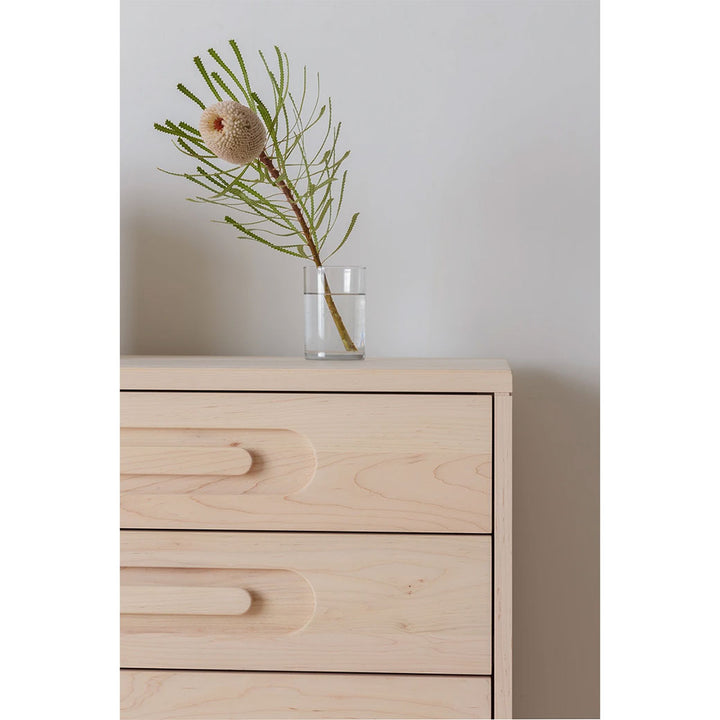 Closeup of right corner of Kalon Caravan Dresser with vase on top in -- Color_Oiled Ash