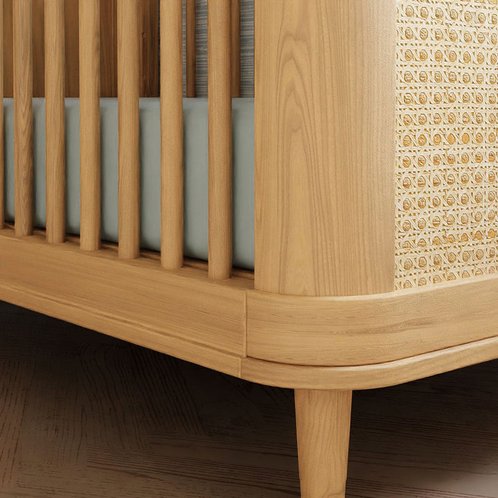 Closeup of The Namesake Marin 3-in-1 Convertible Crib leg in -- Color_Honey/Honey Cane