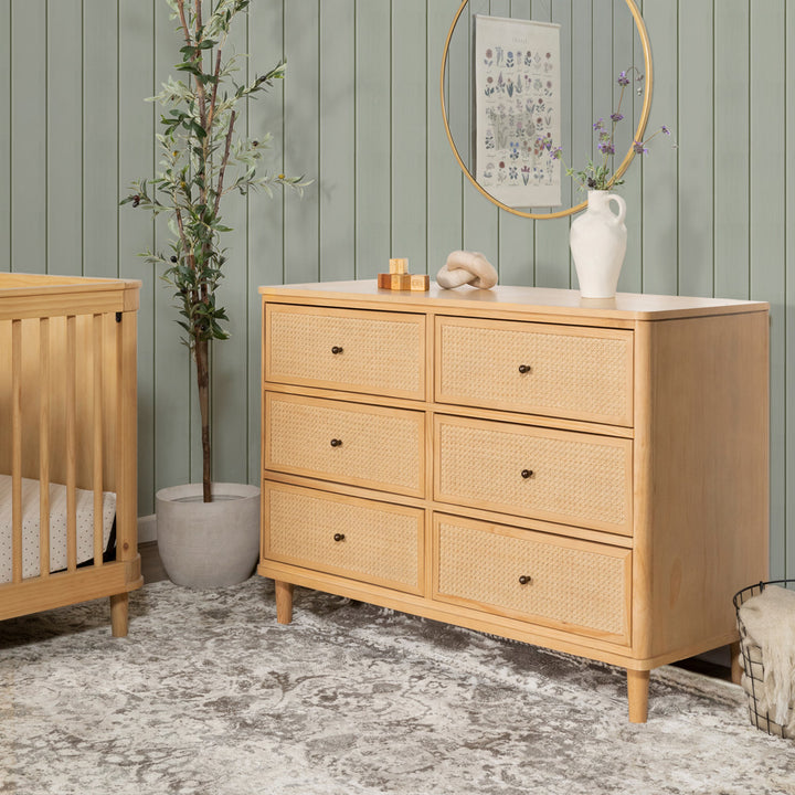 Namesake's Marin 6 Drawer Dresser next to a crib in -- Color_Honey/Honey Cane