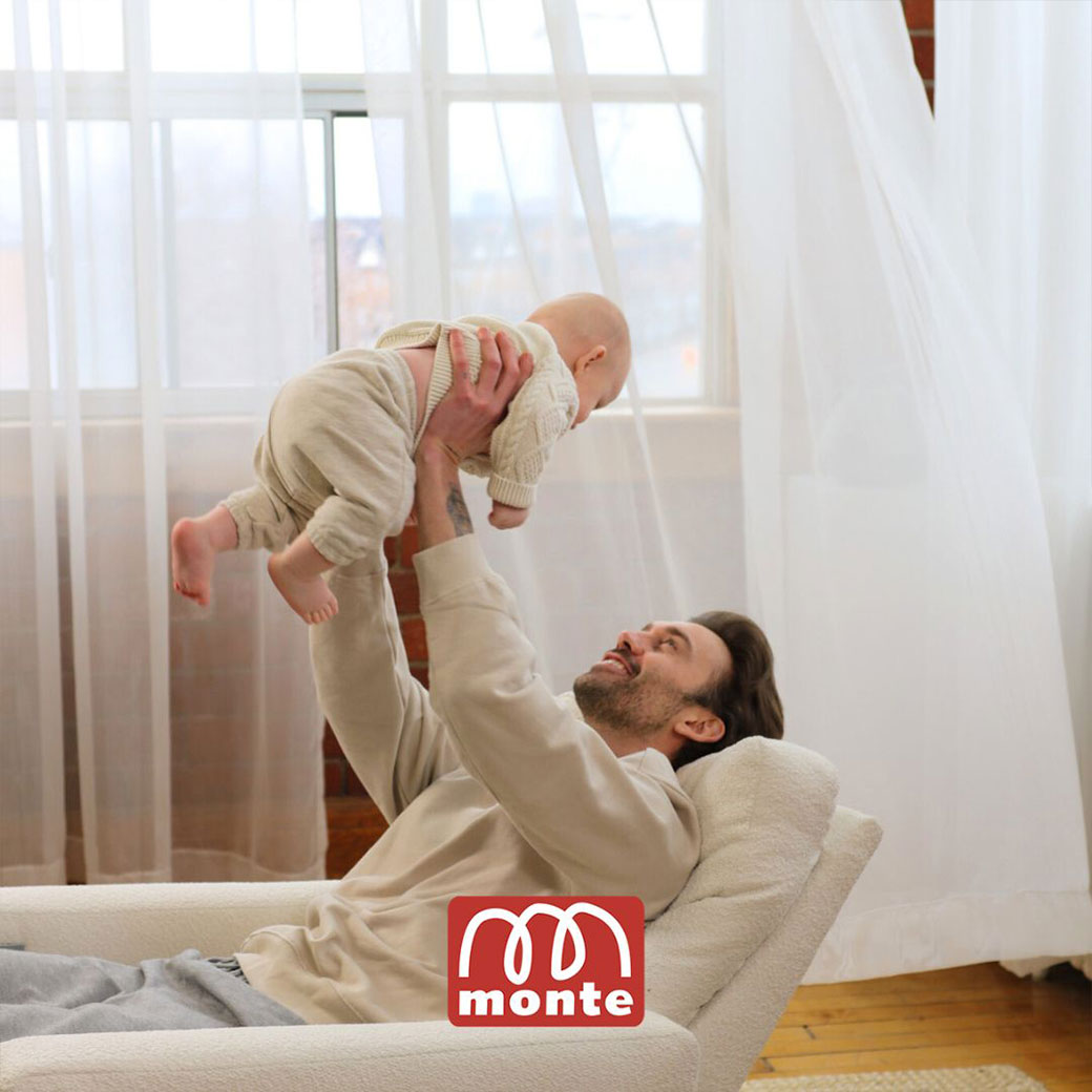 Father holding up baby in Monte Matera Glider Recliner -- Lifestyle