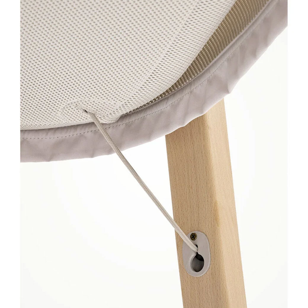 Closeup of the lower part of Stokke Snoozi Bassinet in -- Color_Sandy Beige
