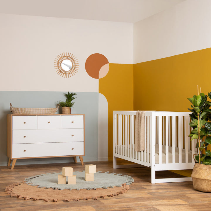 Dadada Austin 3-in-1 Crib next to a dresser  in -- Color_White