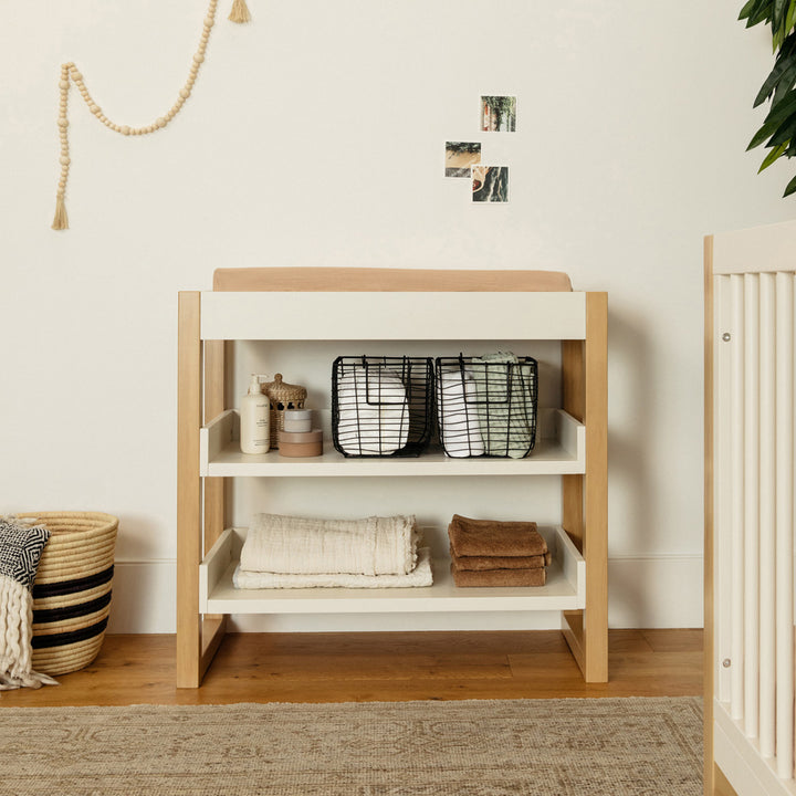 Front view of Namesake's Nantucket Changing Table with items on it in -- Color_Warm White/Honey