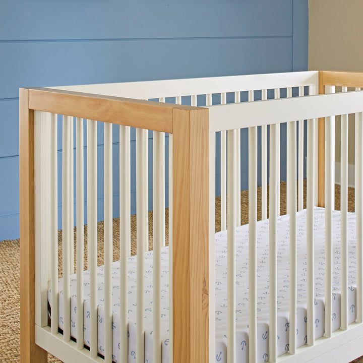 Closeup of rails of Namesake's Nantucket 3-in-1 Convertible Crib in -- Color_Warm White/Honey