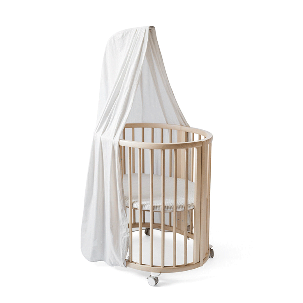 A crib equipped with the Stokke Sleepi V3 Canopy by Pehr in -- Color_Grey