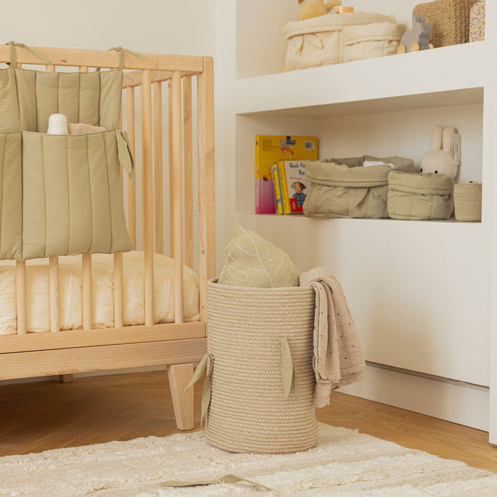 Lorena Canals Bambie Quilted Baskets on a shelf next to a crib  in -- Color_Olive