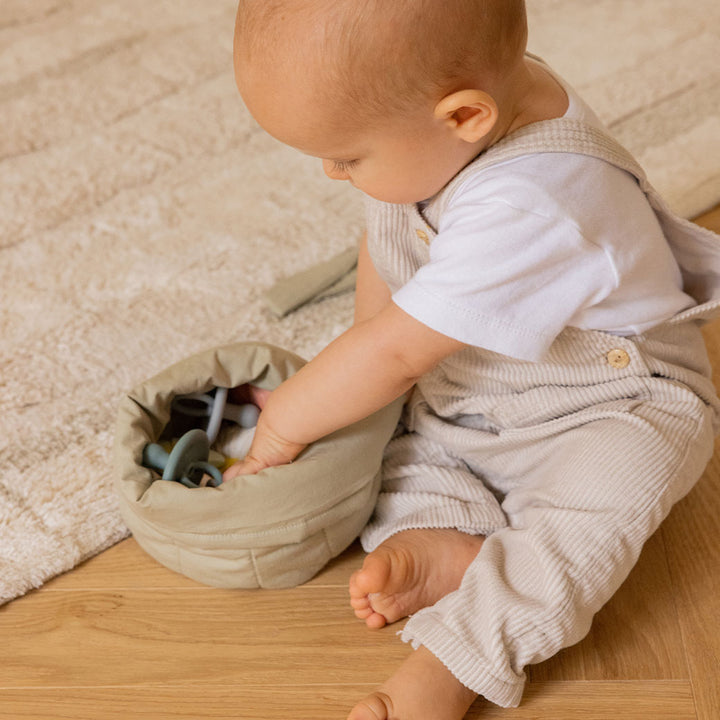 Baby playing with Lorena Canals Bambie Quilted Baskets in -- Color_Olive