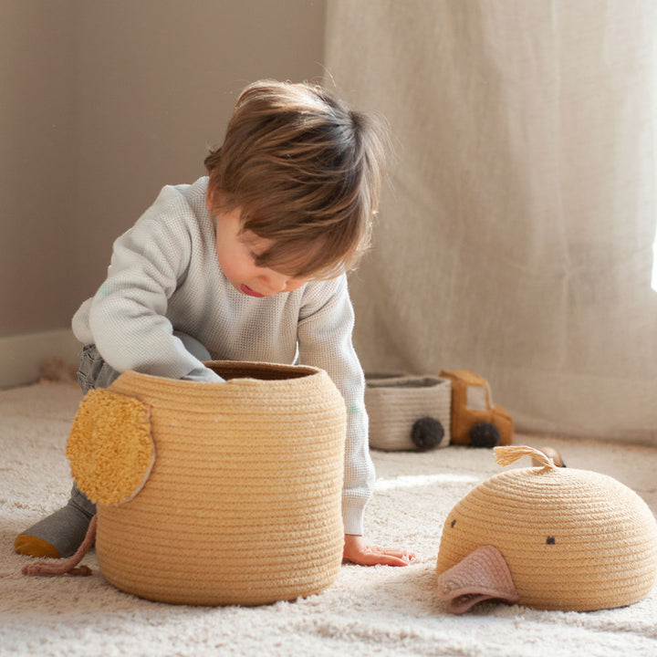 A child in a kid`s room looking inside of the Charlie the Chicken Basket 