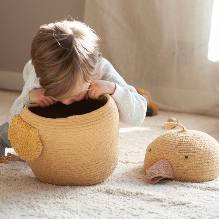 A child looking inside of the Charlie the Chicken Basket 