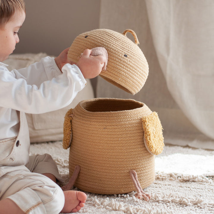 A baby playing with the Lorena Canals Charlie the Chicken Basket 