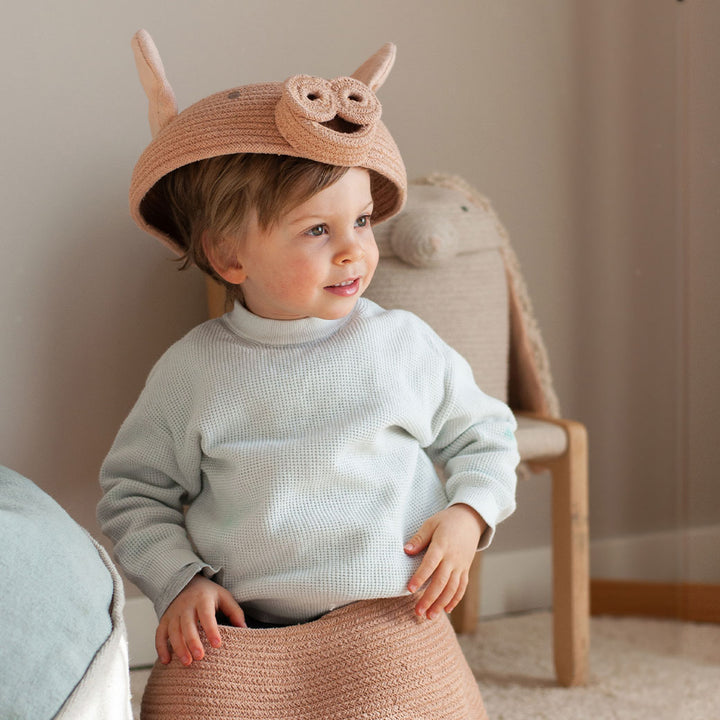 A child playing with the Lorena Canals Peggy the Pig Basket