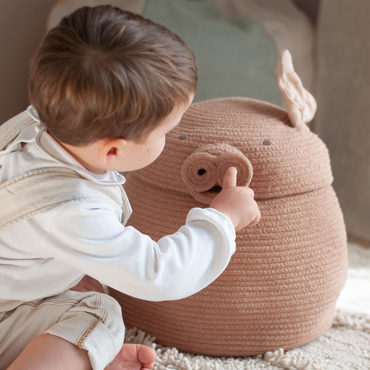 A baby touching the nose of Lorena Canals Peggy the Pig Basket