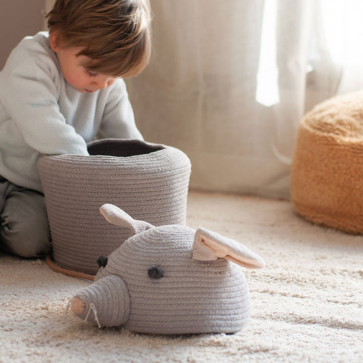 A toddler looking inside the Lorena Canals Renata the Rat Basket