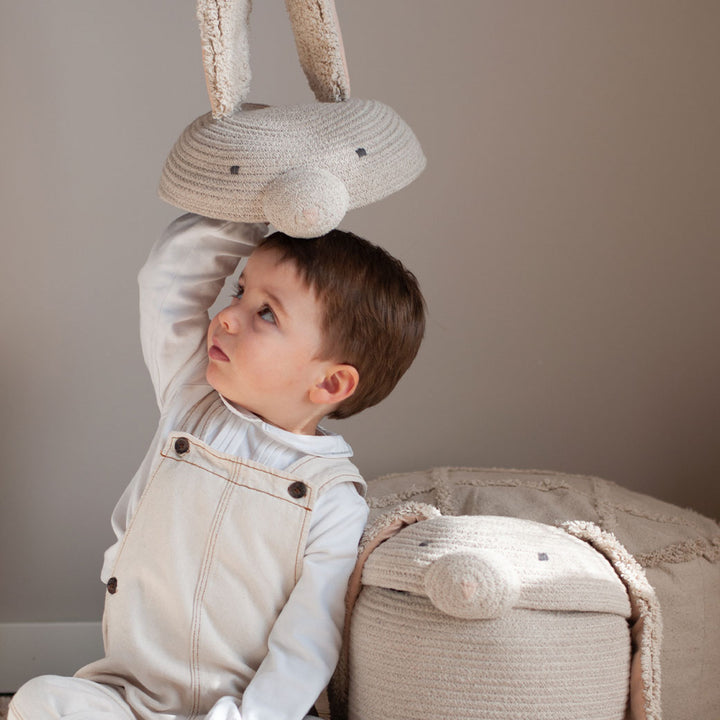 A child with the Lorena Canals Rita the Rabbit Basket top on his head