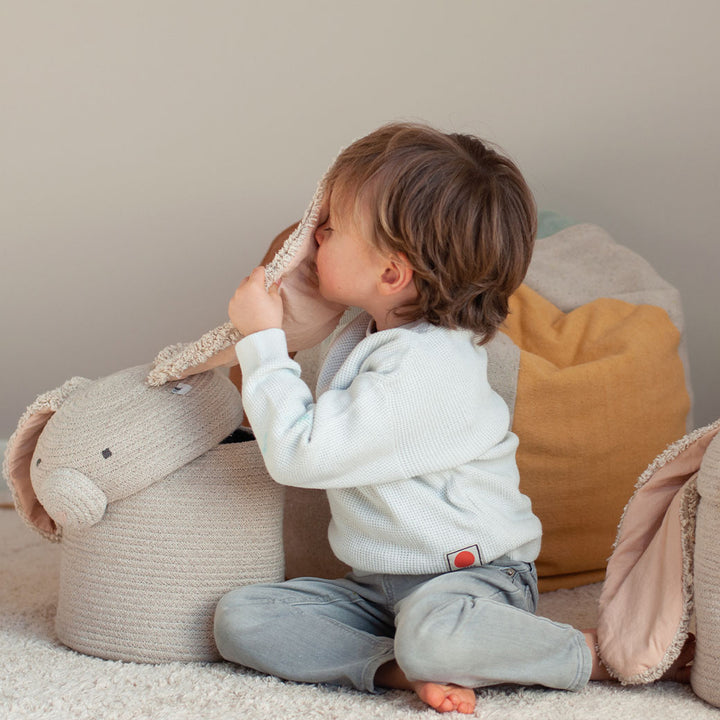 A toddler playing with the ear of Lorena Canals Rita the Rabbit Basket