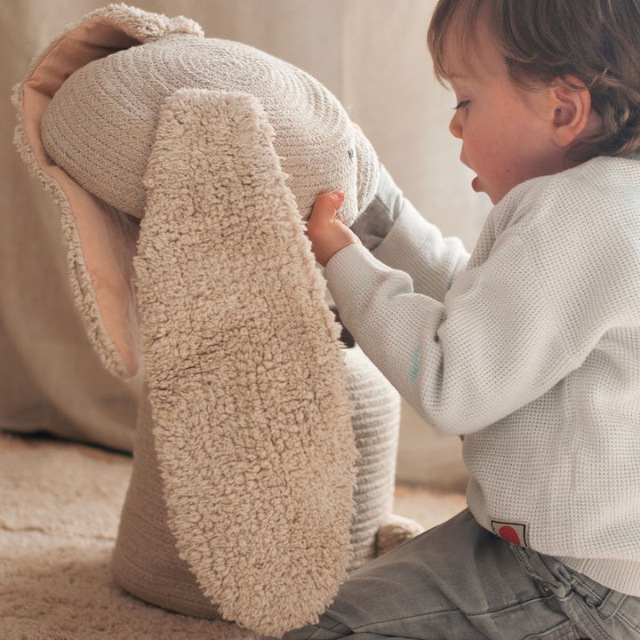 A toddler looking at the top of Lorena Canals Rita the Rabbit Basket