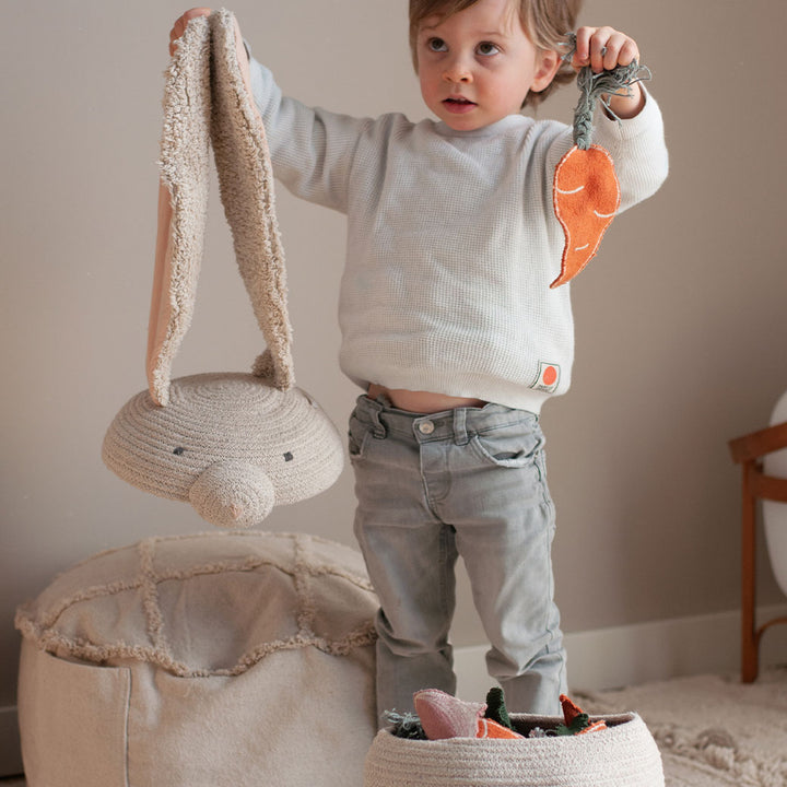 A child holding the top of the Lorena Canals Rita the Rabbit Basket